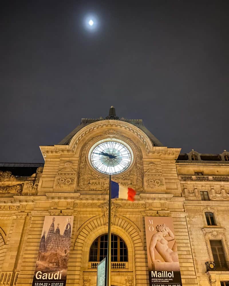 Musée d'Orsay clock at night with moon, Paris.