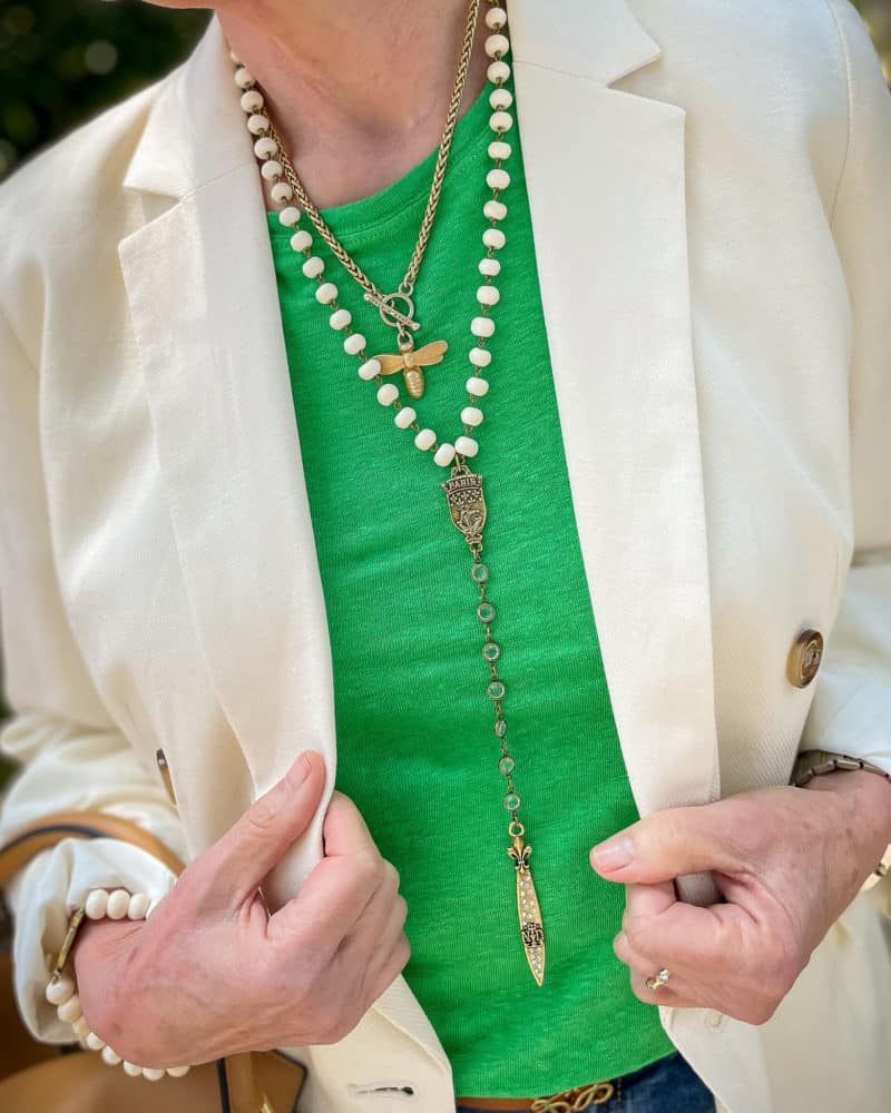 Detail: Susan B. wears an ivory blazer, green linen tee, and French Kande necklaces.