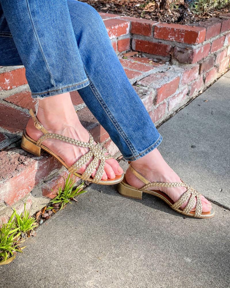 Susan B. wears jeans and gold braided Sézane sandals.