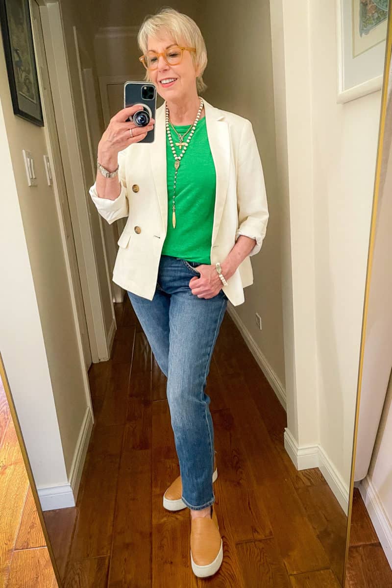 Susan B. wears a casual blazer outfit with a green linen tee, jeans, platform sneakers and layered French Kande necklaces.