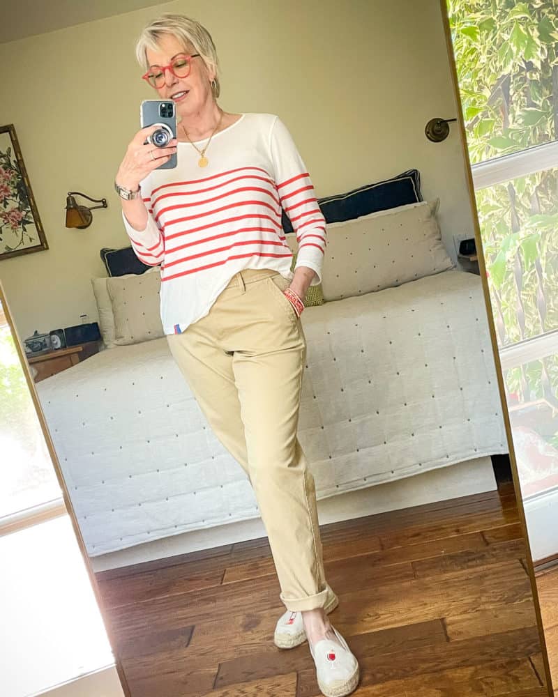 Susan B. wears a summer outfit with lightweight chino trousers and a Breton stripe tee.