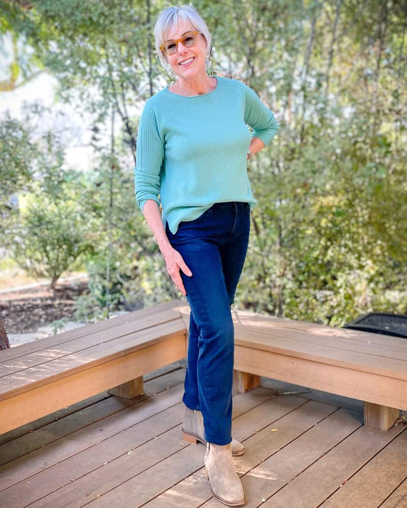 Susan B wears an Eileen Fisher merino sweater in aqua, dark wash jeans and suede ankle boots. More wardrobe basics on sale at une femme d'un certain age.