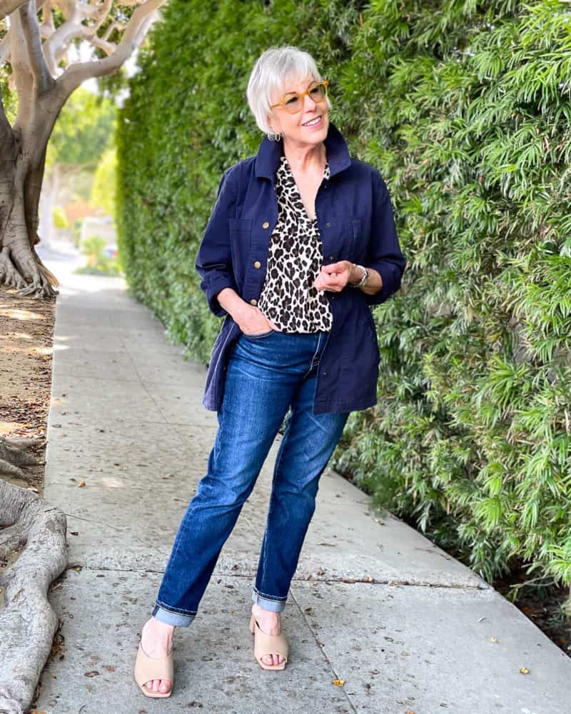 Wardrobe basics on sale: Susan B wears a navy utility jacket, leopard print top, boyfriend jeans and nude slide sandals.