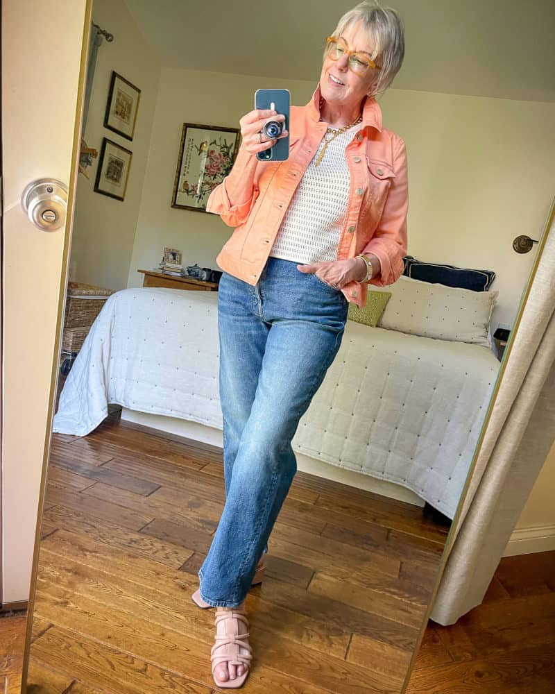 Susan B. wears a colored denim jacket outfit with a crochet top and relaxed leg jeans. Details at une femme d'un certain age.