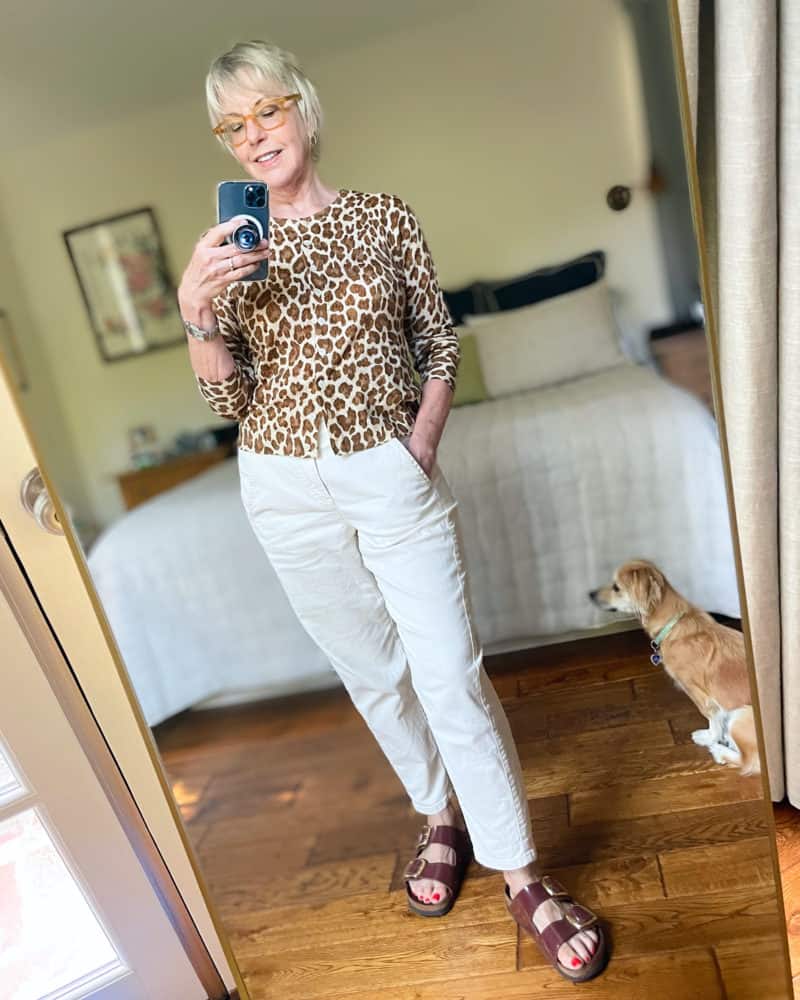 Susan B. wears a J.Crew leopard print sweater, off white denim pants, birkenstock sandals.