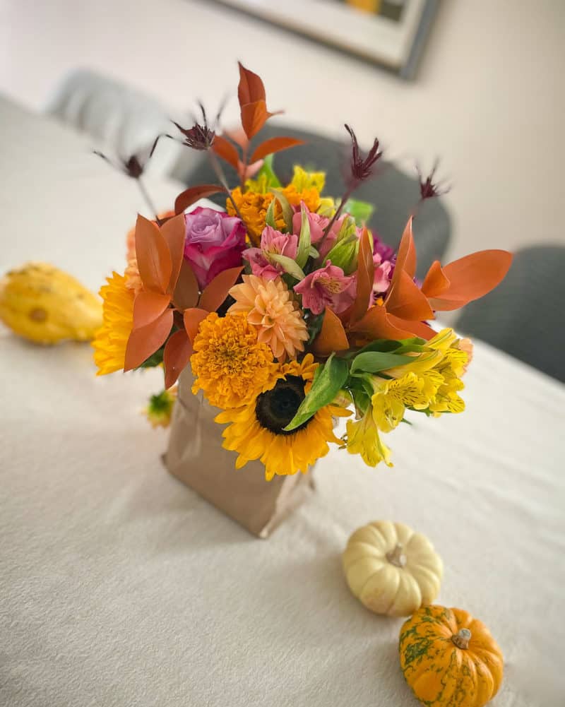 Fall centerpiece with sunflowers, dahlias, rose, freesia.