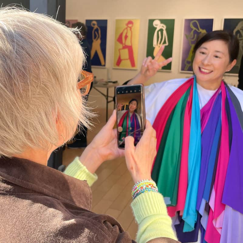 Susan B. taking a photo of a color analysis client draped in the Winter palette colors.