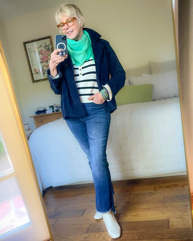 How to use the 3-color rule: Susan B. wears a cream and navy striped sweater, navy jacket, green scarf and bracelets, jeans, cream ankle boots.