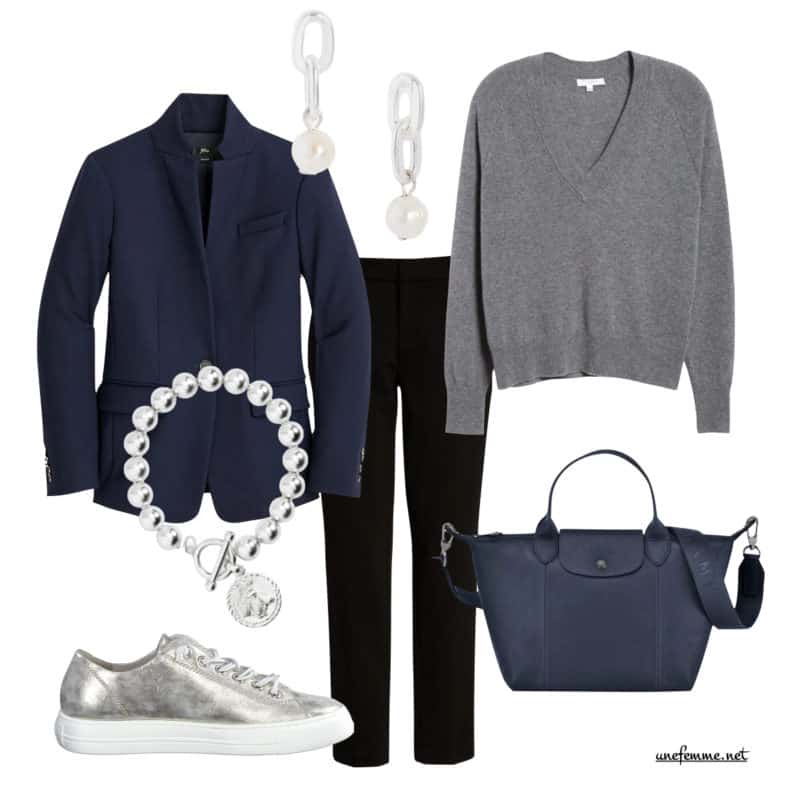 Simple effortless chic outfit in cool-toned neutrals. Navy blazer, pearl drop earrings, v-neck sweater, silver charm bracelet, black knit trousers, metallic sneakers, navy Longchamp bag.