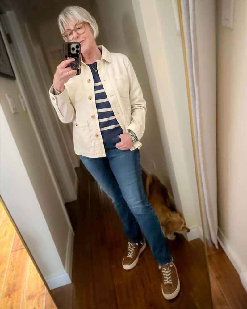 Susan B. takes a mirror selfie wearing Talbot's shirt jacket, J.Crew striped cashmere sweater, straight leg jeans, brown sneakers.