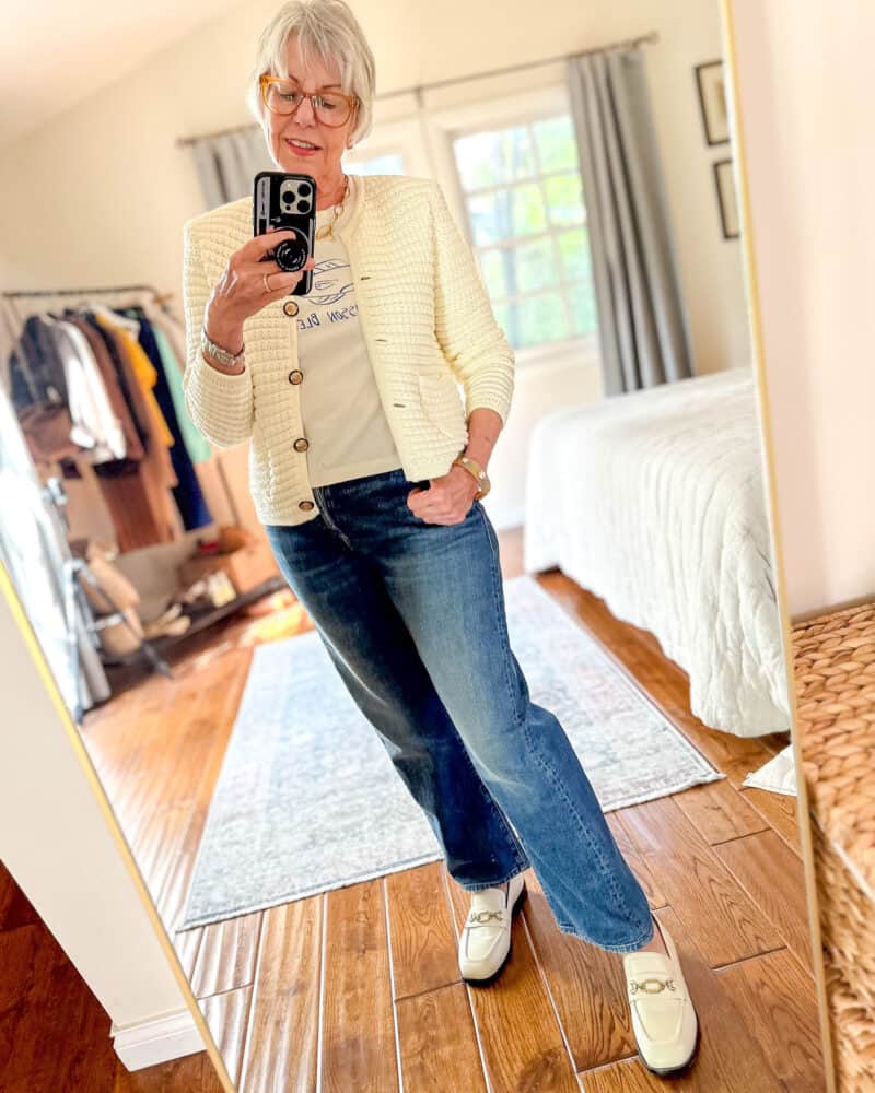 Susan B. wears a ba&sh "Gaspard" cardigan with a graphic tee, wide leg jeans, ivory loafers