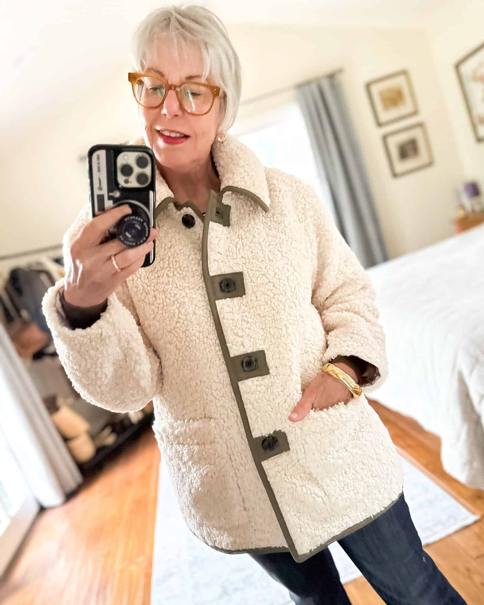 Susan B. wears a J.Crew sherpa teddy jacket and gold bracelet