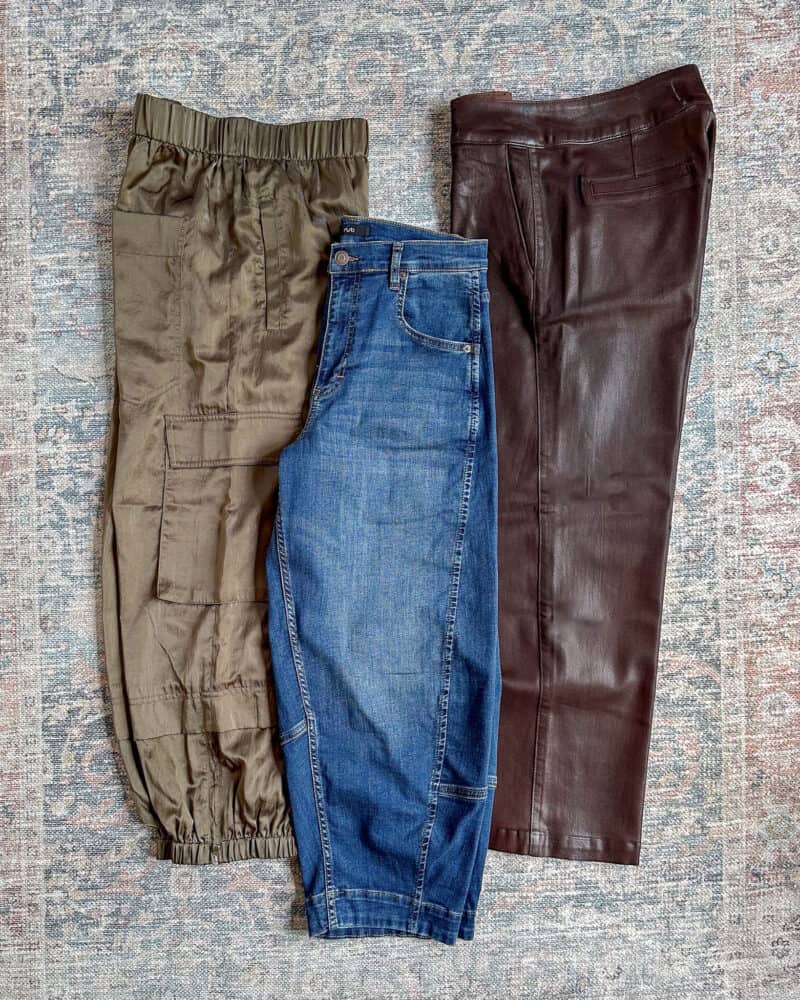 Spring travel capsule wardrobe bottoms: silky cargo pants, barrel-leg jeans, coated denim trousers.