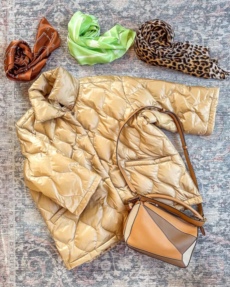 Travel outerwear & accessories: silk & cashmere scarves, packable down jacket, crossbody bag.