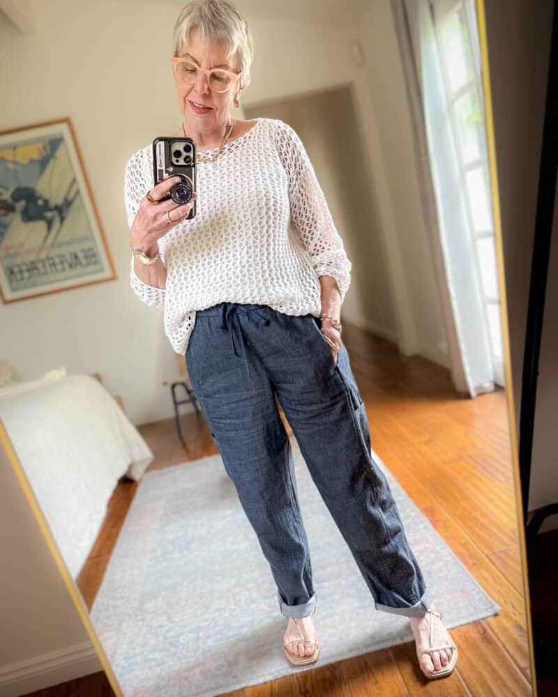 Susan B. wears an ivory Eileen Fisher cotton crochet summer top over an ivory tank, and cotton twill drawstring pants.