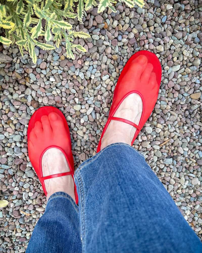 Details: Susan B. wears blue jeans and Jeffrey Campbell red mesh ballet flats