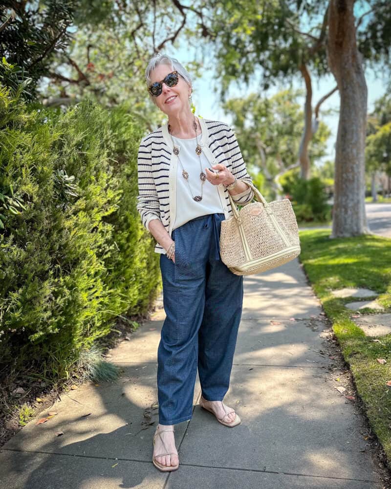 Polished casual outfit: Susan B. wears a rag & bone striped cardigan, tortoise-look station necklace, silk shell, Eileen Fisher drawstring cargo jeans, raffia bag, and gold strappy sandals.