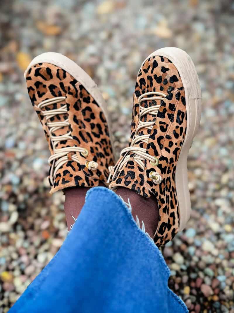 Detail: Susan B. wears leopard print Paul Green sneakers.
