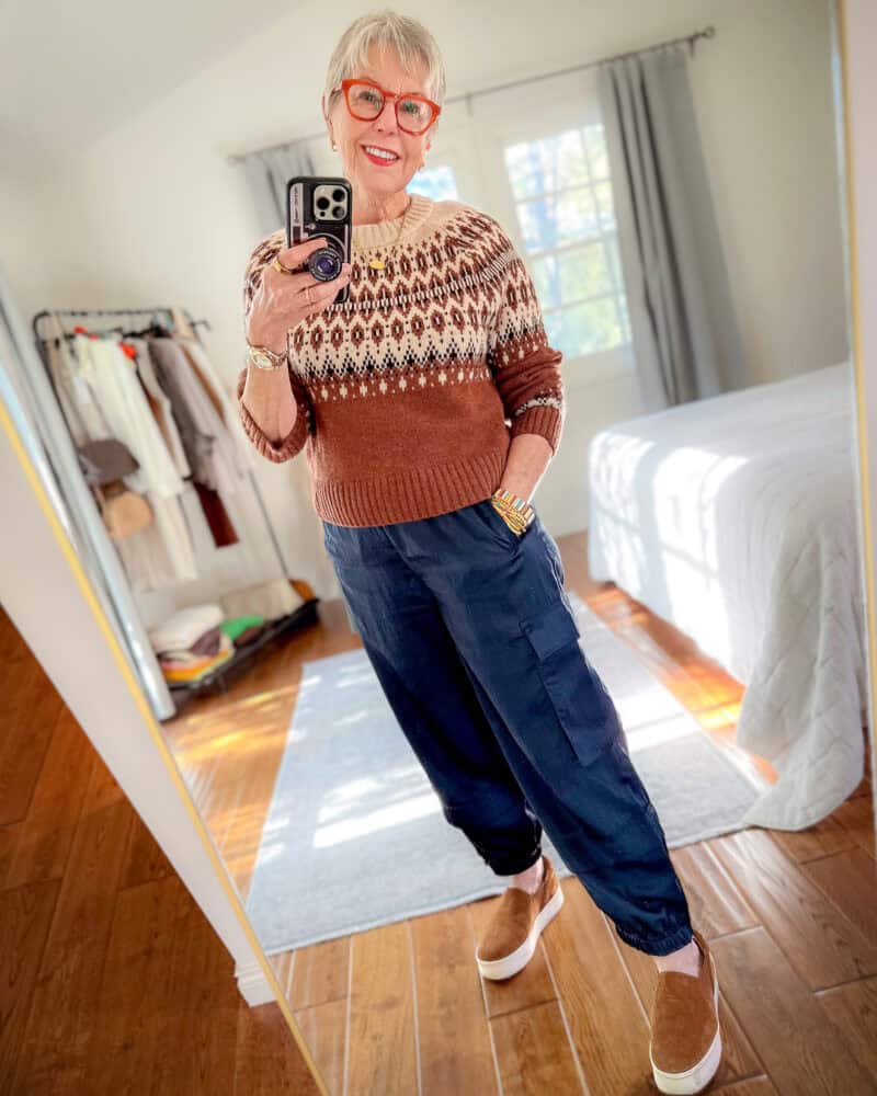 Susan B. wears a Fair Isle sweater with silky joggers and slip-on suede sneakers.