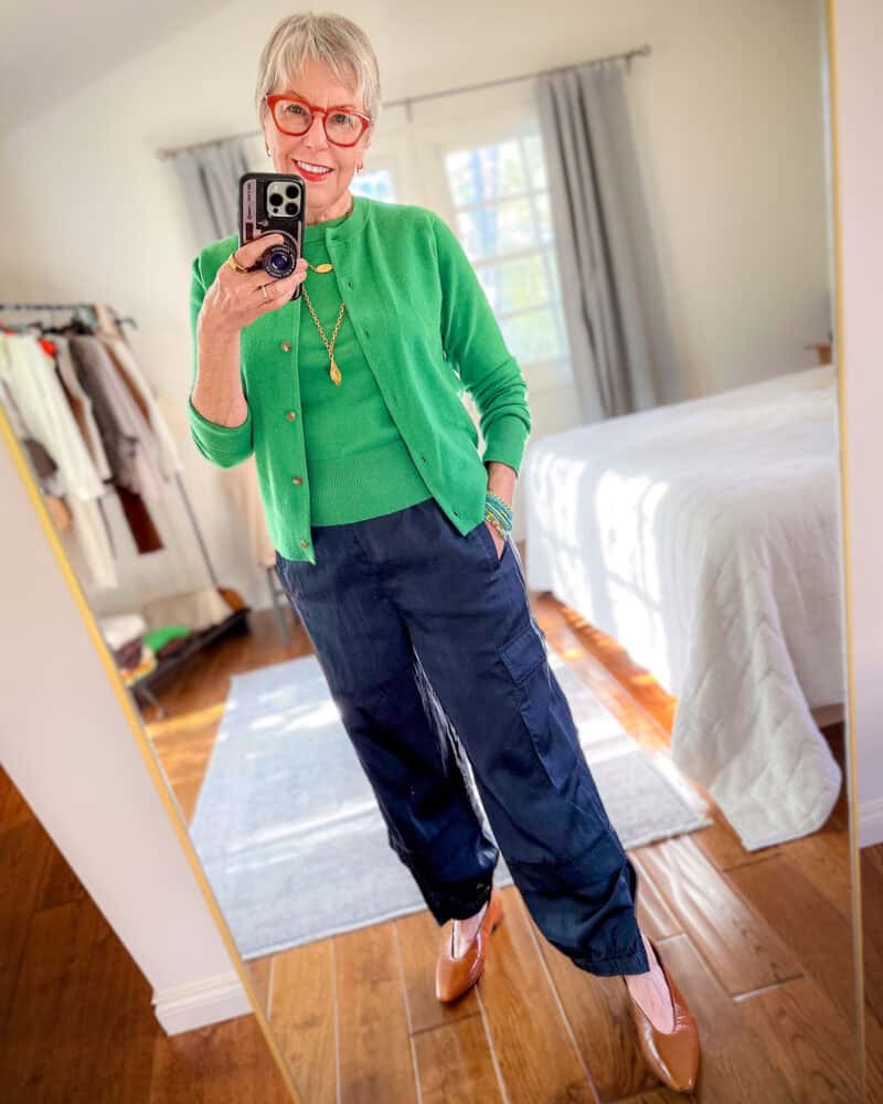 Silky joggers outfit: Susan B. wears a green shell and cardigan, navy satin joggers, pointed-toe flats, gold layered necklaces.