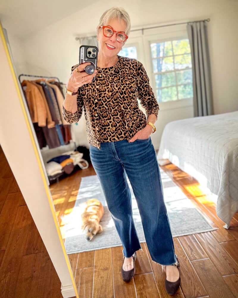 Susan B. wears a leopard print sweater twinset with straight leg jeans and brown mary jane flats.