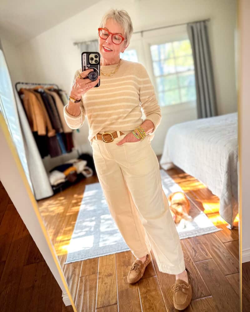 Susan B. wears a beige/cream striped sweater with ecru barrel leg pants and suede boat shoes.