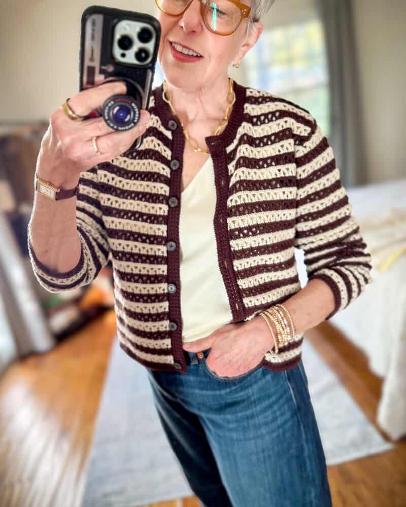 Detail: Susan B. wears an open stitch stripe cardigan from Madewell.
