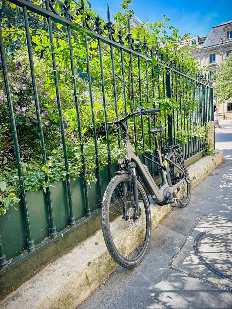 bicycle leans against fence, Paris.