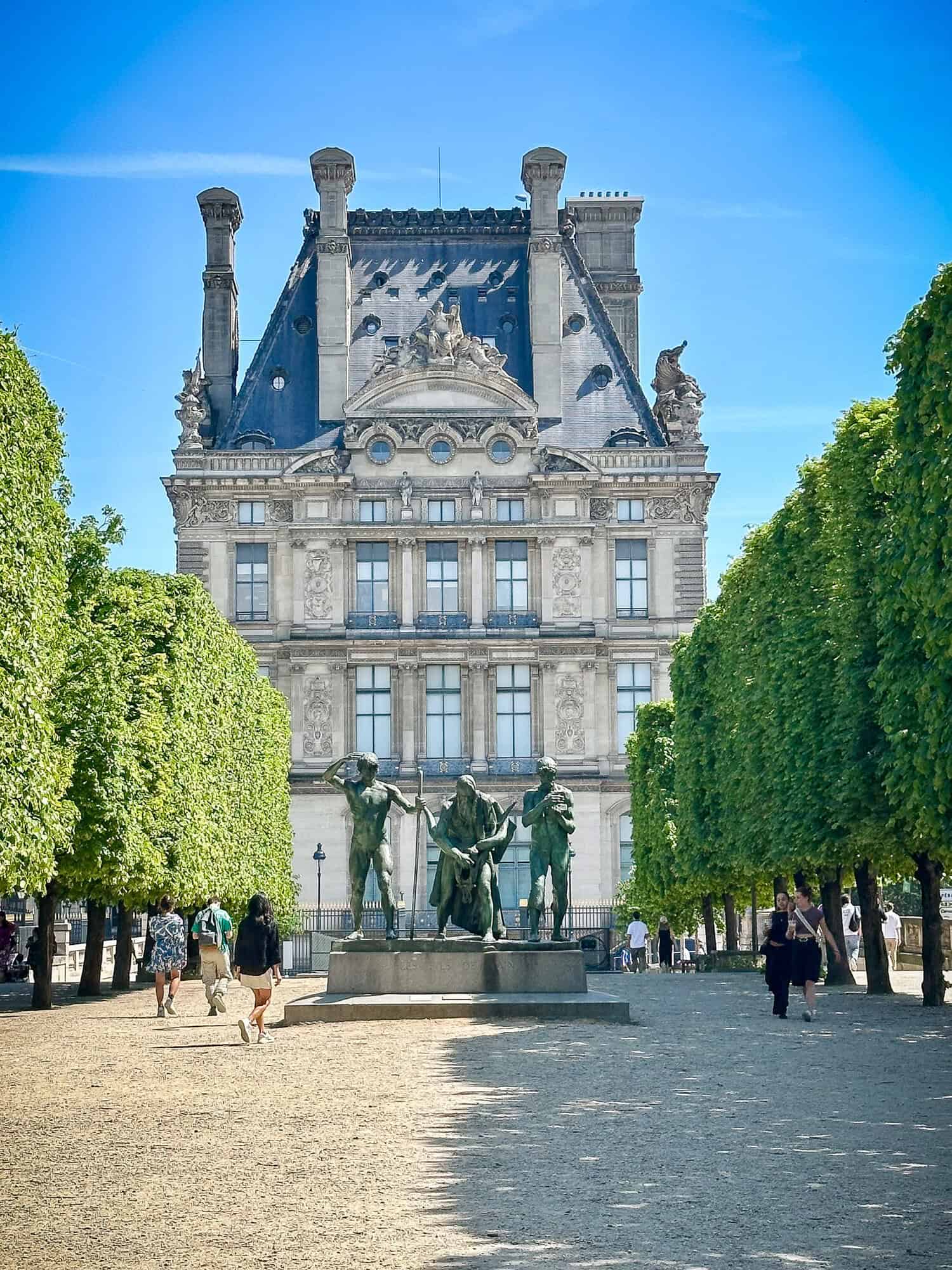 Louvre, Paris, as seen from the Jardin des Tuileries with a statue in foreground.