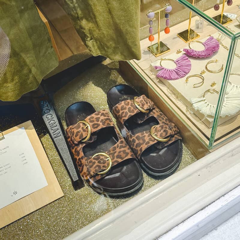 Leopard print sandals in a Paris shop window.