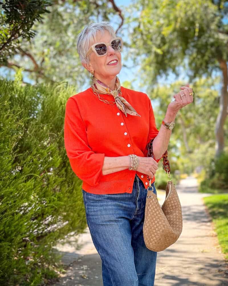 Susan B. wears a silk bandana, Madewell cotton cardigan, darted leg jeans, Clare V woven messenger bag with resin link strap.