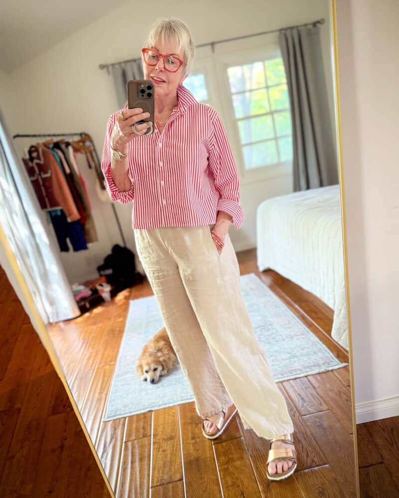 Susan B. wears a red and white striped cotton poplin shirt, linen pants, metallic Birkenstock sandals.