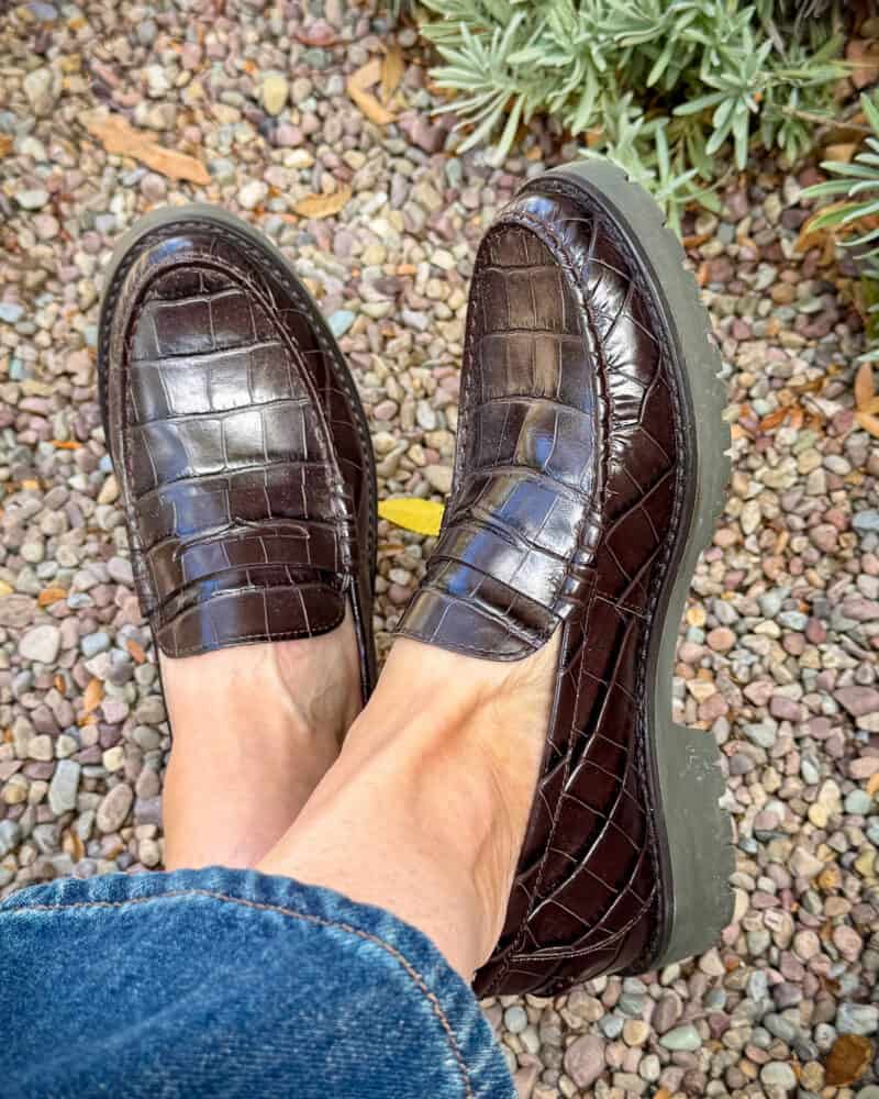 Detail: Susan B. wears Cole Haan lug-sole loafers in brown croc effect leather.