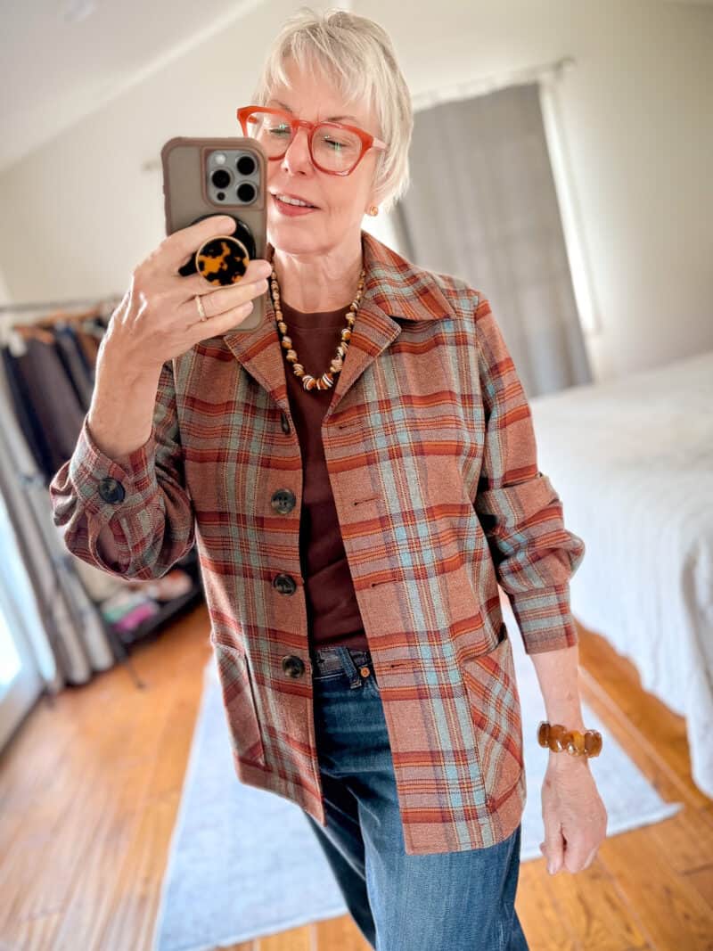 Detail: Susan B. wears a plaid Pendleton 49er jacket with a brown tee, jeans, and vintage jewelry.