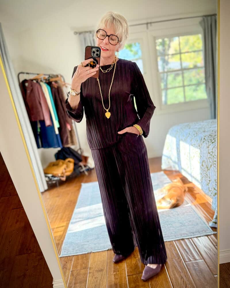 Susan B. wears a chocolate brown pleated top and pants from Ruti.
