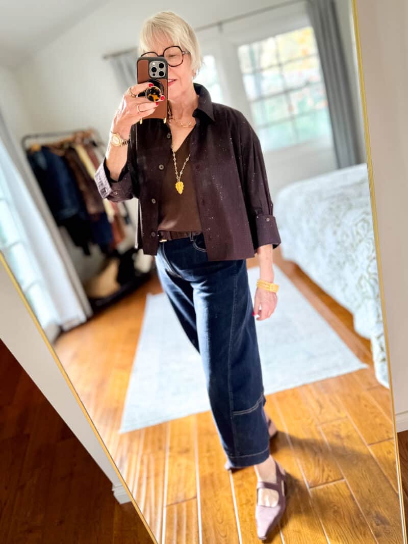 Susan B. wears a sparkly brown poplin shirt, brown silk tank, barrel jeans, brown pointed toe flats.