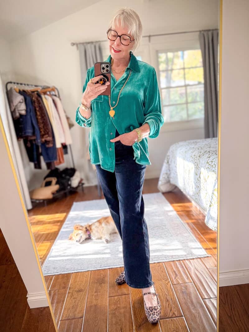 Festive casual outfits with jeans: Susan B. wears a light teal velvet shirt, gold and pearl jewelry, dark wash jeans, leopard print shoes.