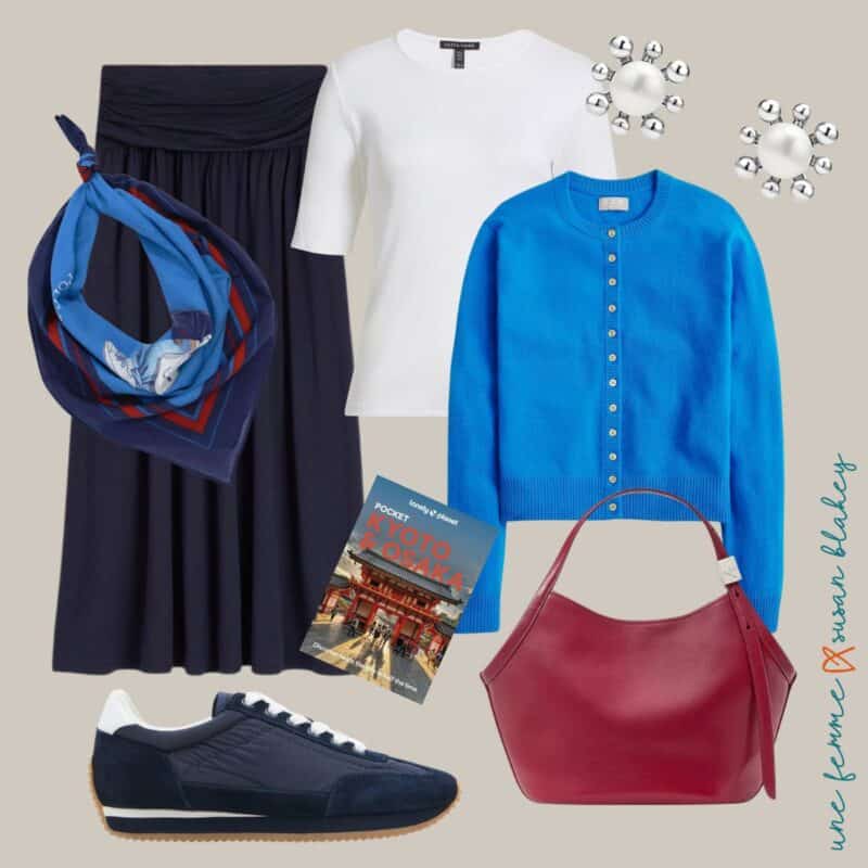 Spring travel outfit idea with a navy skirt, Ralph Lauren bandana, white tee, bright blue cashmere cardigan, pearl and silver earrings, navy waterproof sneakers, cool red leather bag.