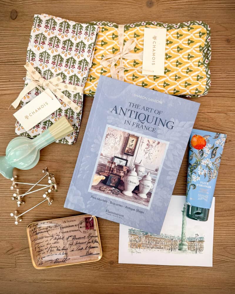 Gifts from My French Country Home Box by Sharon Santoni. Antiquing book, vase, printed cloth placemats and napkins, silver knife rests, body lotion, catch-all tray, illustration of Place Vendome.