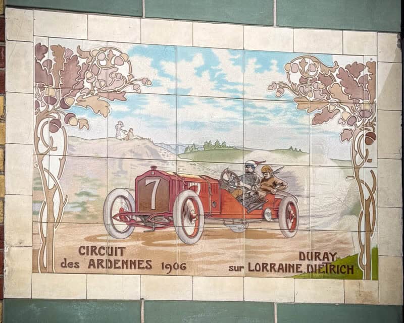 Decorative tile featuring 1906 auto racing on Michelin building, London.