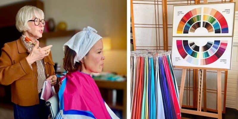 A personal color analyst drapes colorful fabric swatches over a seated client wearing a white head covering, a seasonal color wheel chart displaying Autumn, Spring, Winter, and Summer palettes stands nearby on an easel next to color drapes.