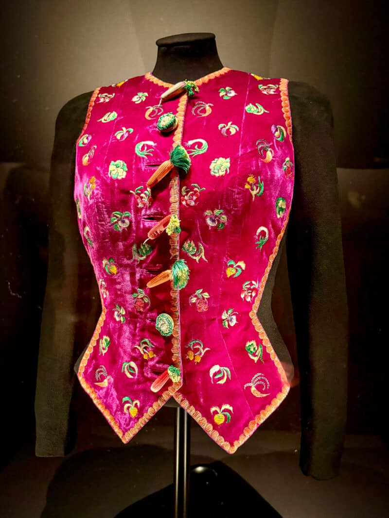Embroidered vest with carrot buttons at Schiaparelli exhibition at V&A in London.
