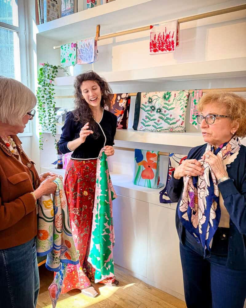 Trying scarves at Petitjean Paris during Paris Fashion Tour with Susan Blakey.