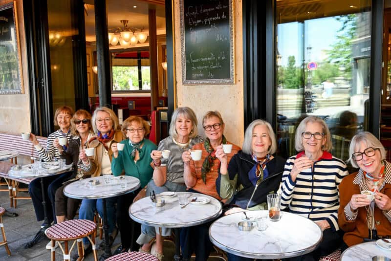 Paris Fashion Tour group enjoys a coffee break at cafe.