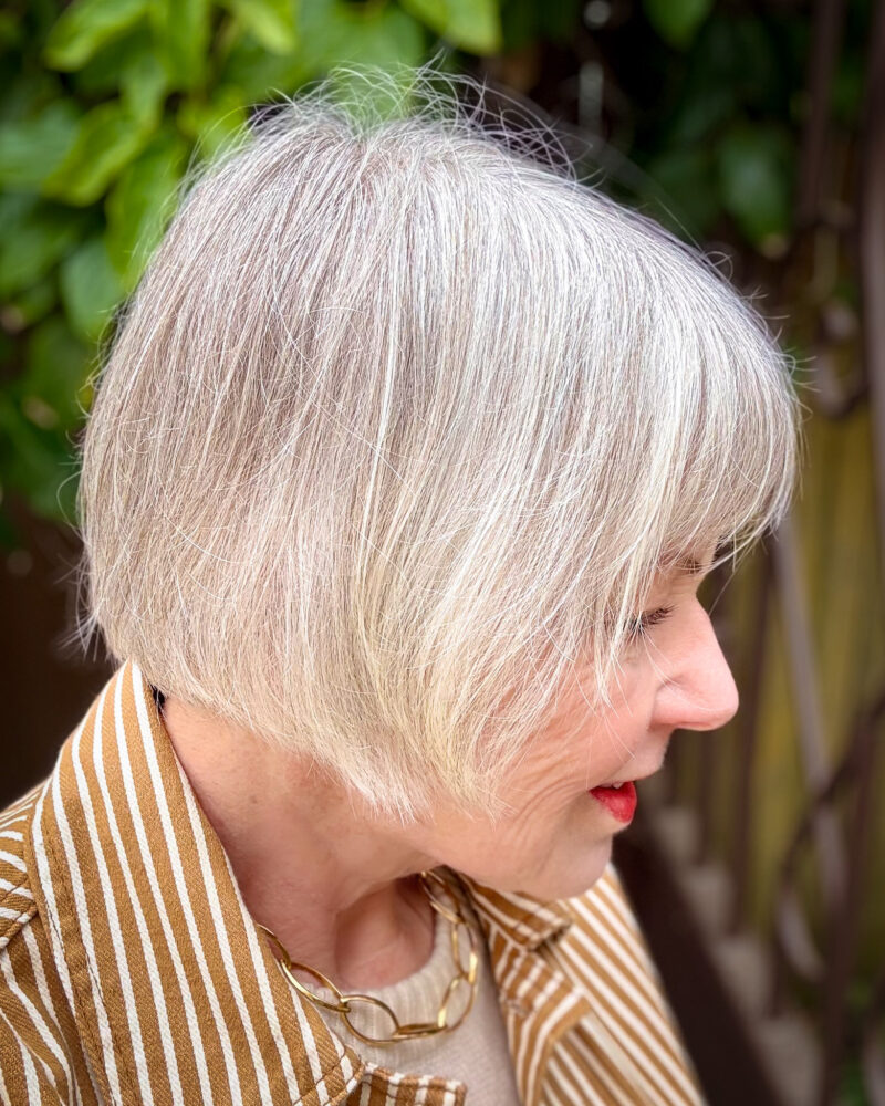 Silver grey French bob haircut side view — a chic, low-maintenance style for women with grey hair.