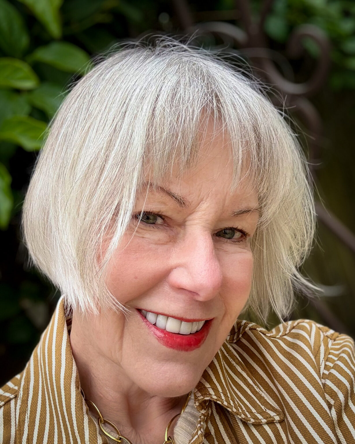 Silver grey French bob haircut with wispy bangs — a chic, low-maintenance style for women with grey hair