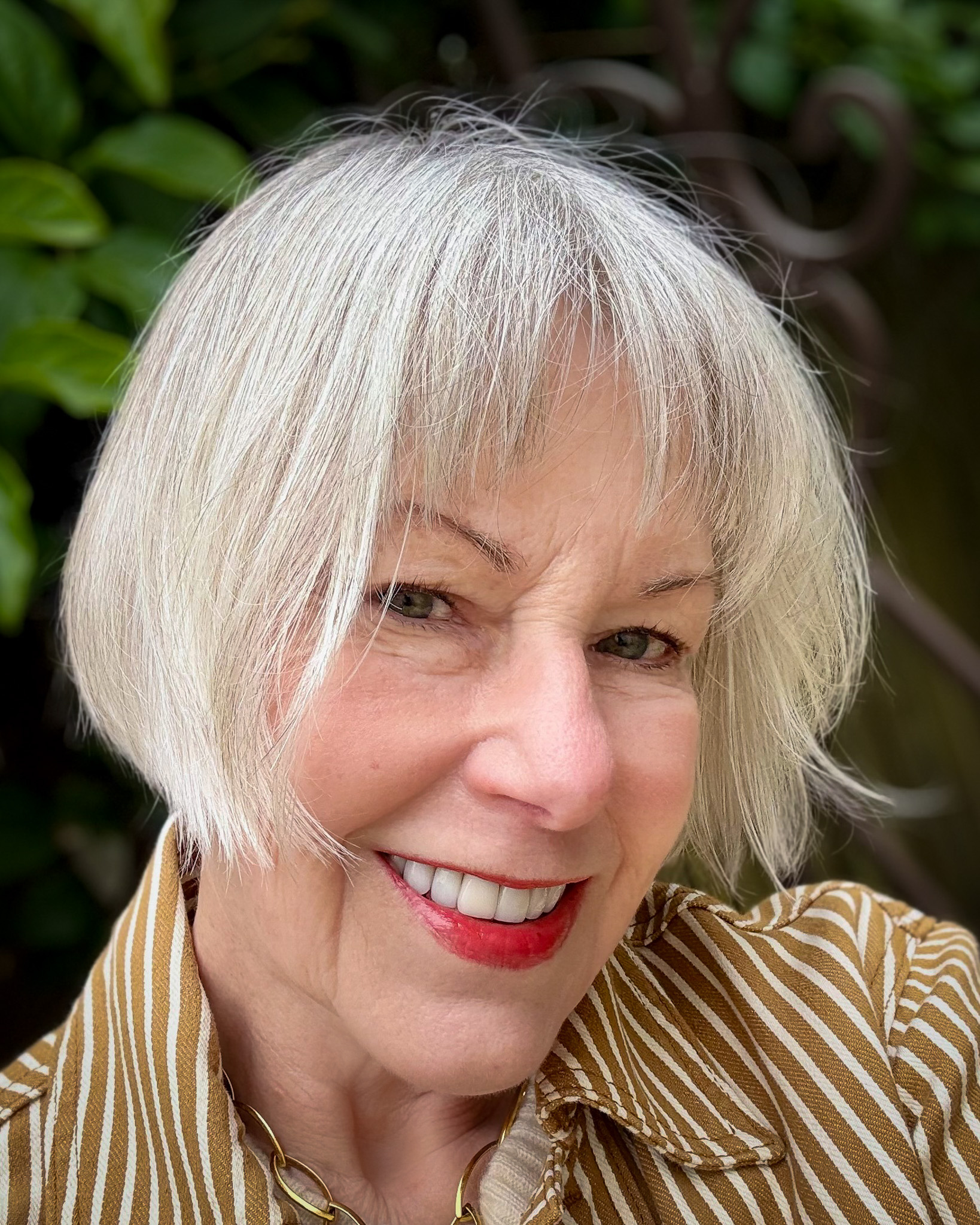 Silver grey French bob haircut with wispy bangs — a chic, low-maintenance style for women with grey hair