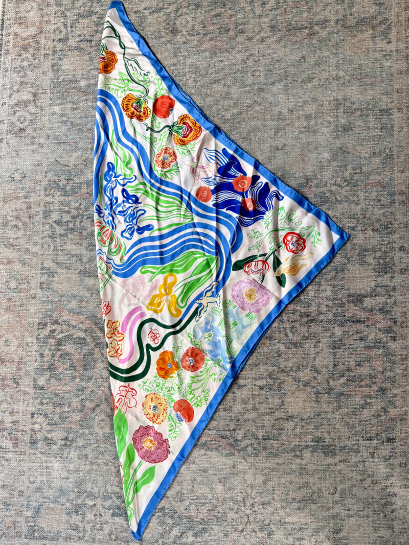 Printed silk square scarf folded on the diagonal.