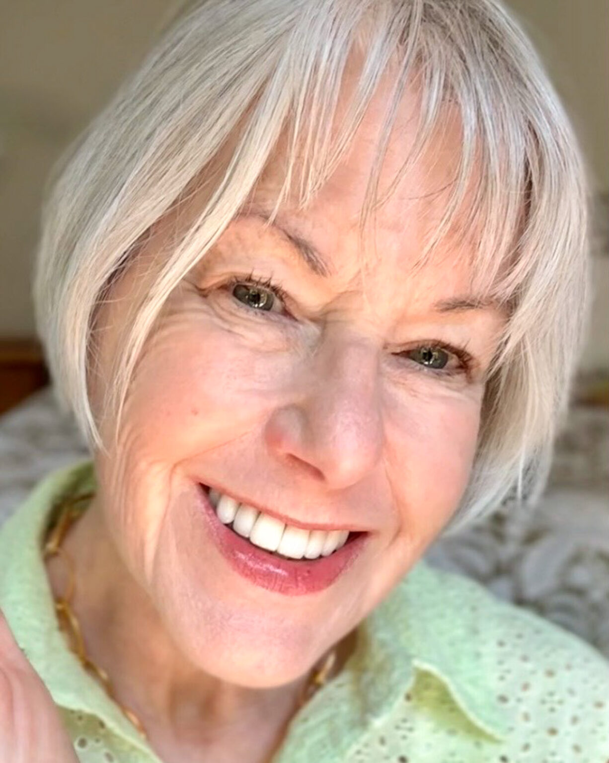 Close-up of Susan's face showing a natural summer makeup look, soft pink lip and fresh skin.