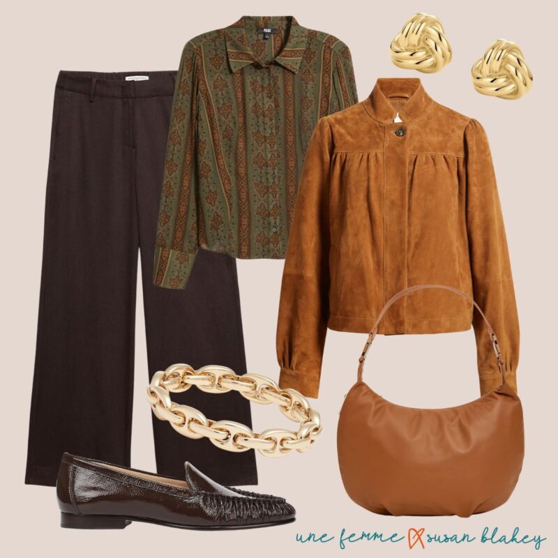 Travel outfit idea in warm neutrals: dark brown trousers, olive and rust blouse, cognac suede jacket, gold earrings and bracelet, dark brown patent loafers, brown leather bag.